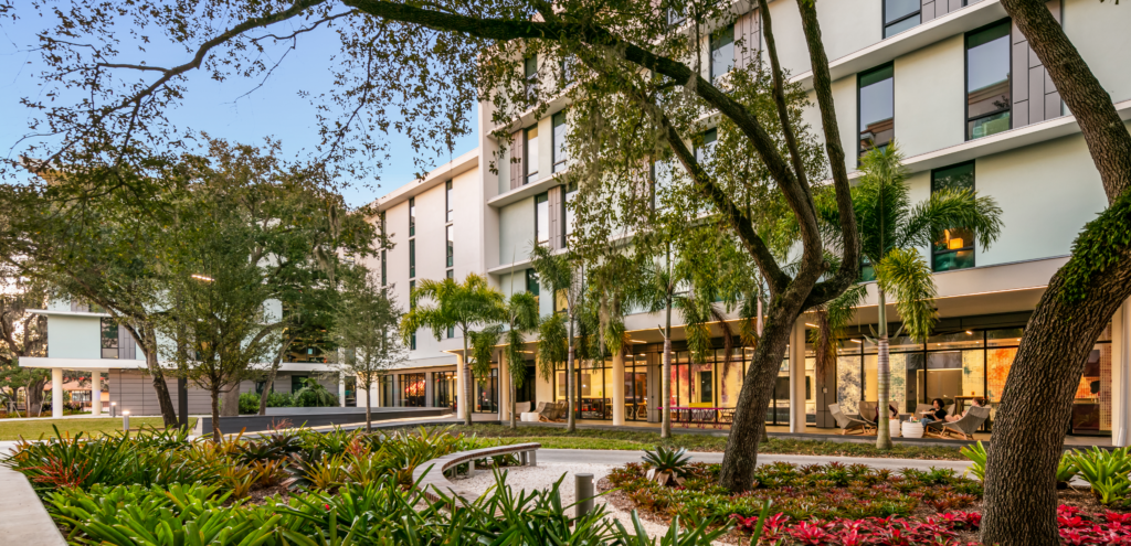 Photo of campus grounds, a building, and trees