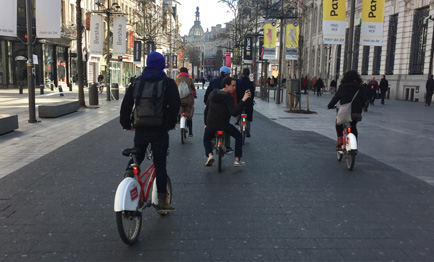 Several People Biking Through a City Street