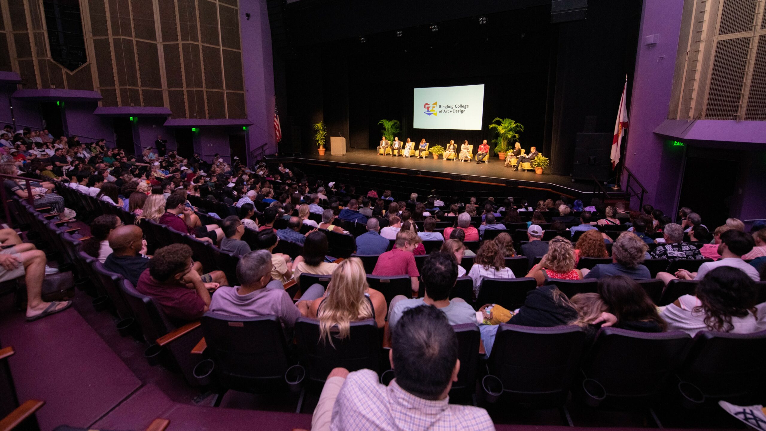 A stage facing a theater full of guests