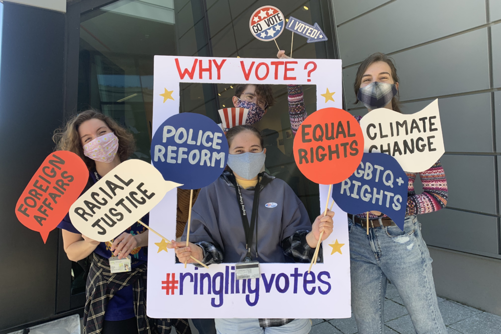 Students Standing in and around signs urging people to vote