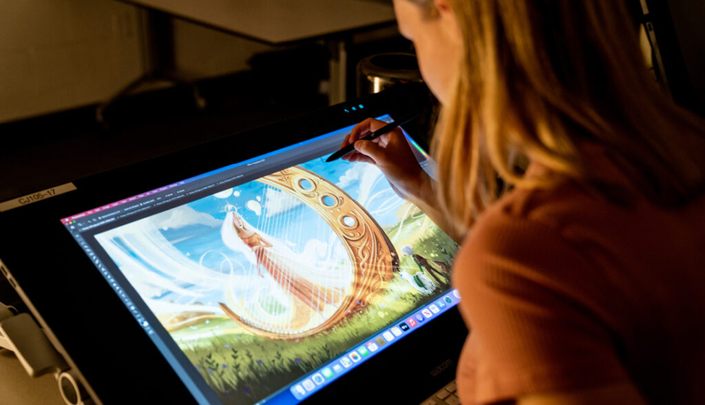 a girl creating art on a tablet computer