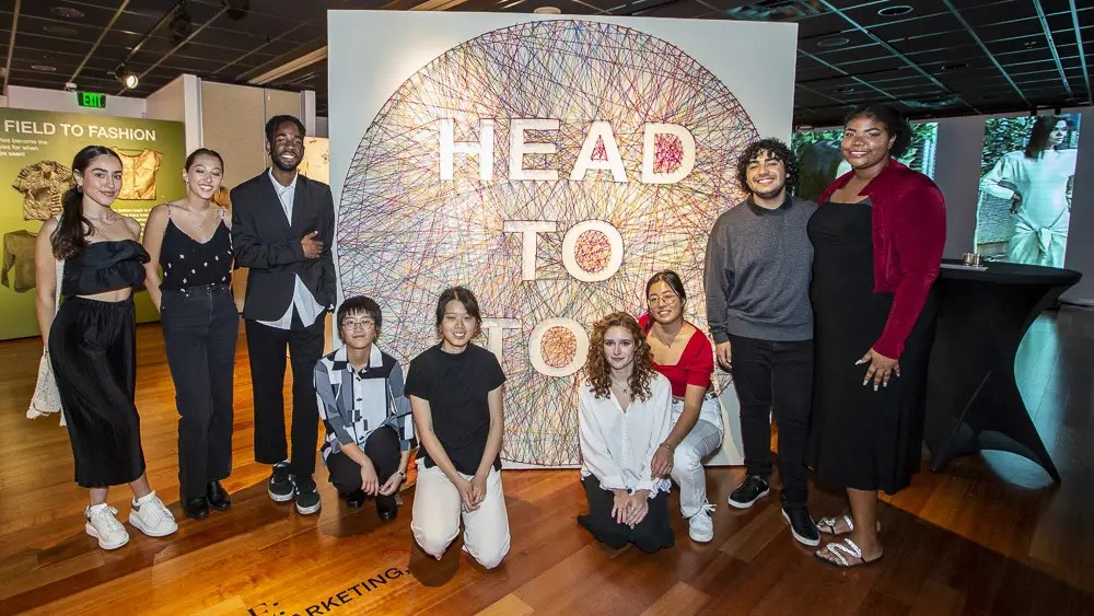 The Head to Toe exhibit was led by a student curatorial team participating in a semester-long Business of Art and Design class titled Role of the Curator. The students are seen here during an opening event on Nov. 8.