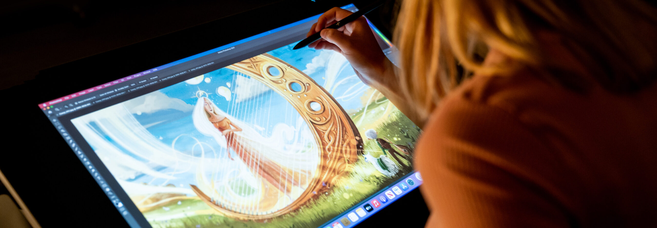 A student creating art at a tablet computer