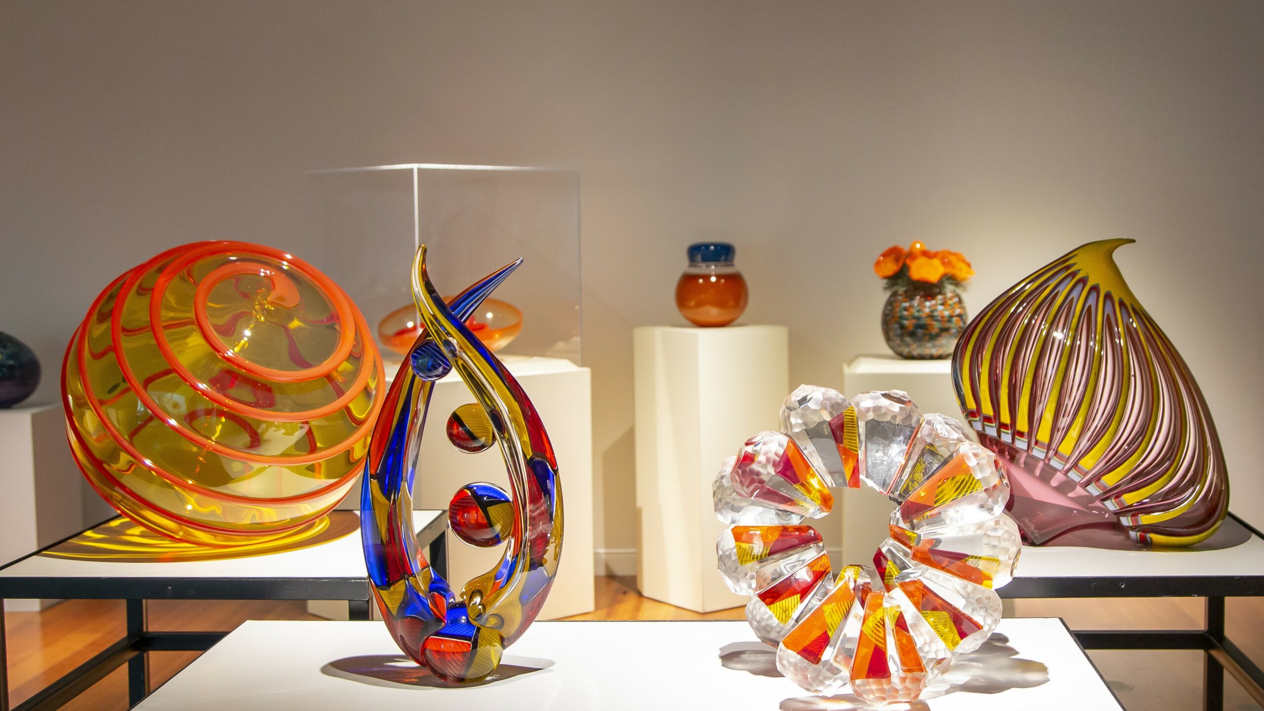 Four sculptures by Seattle-based glass artist Richard Royal from the exhibition Circles and Spheres at the Richard and Barbara Basch Gallery, currently on view until March 24, 2023.