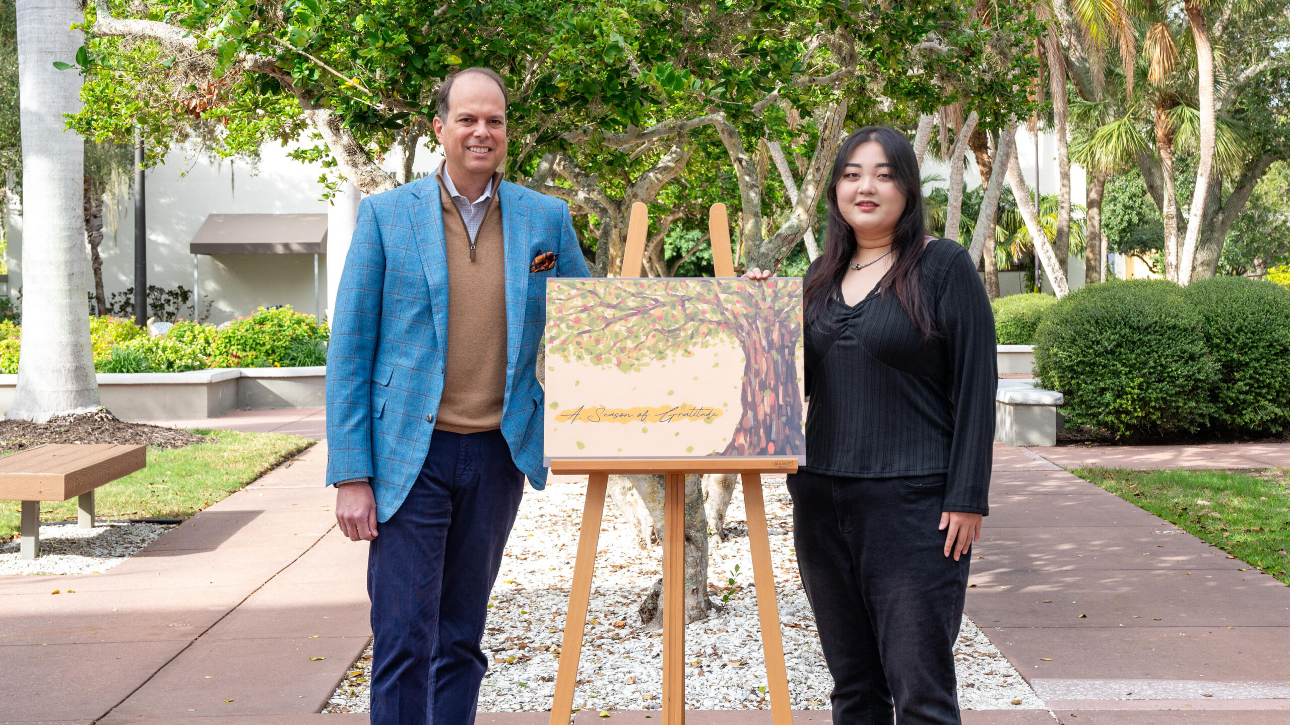 Stella Kim and Michael Wilson pose with the award-winning card art work.