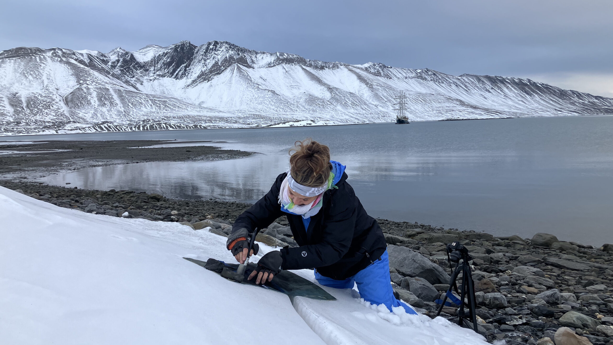 Eszter Szikz printing with ash and a silk screen onto the snow in the Arctic Circle.