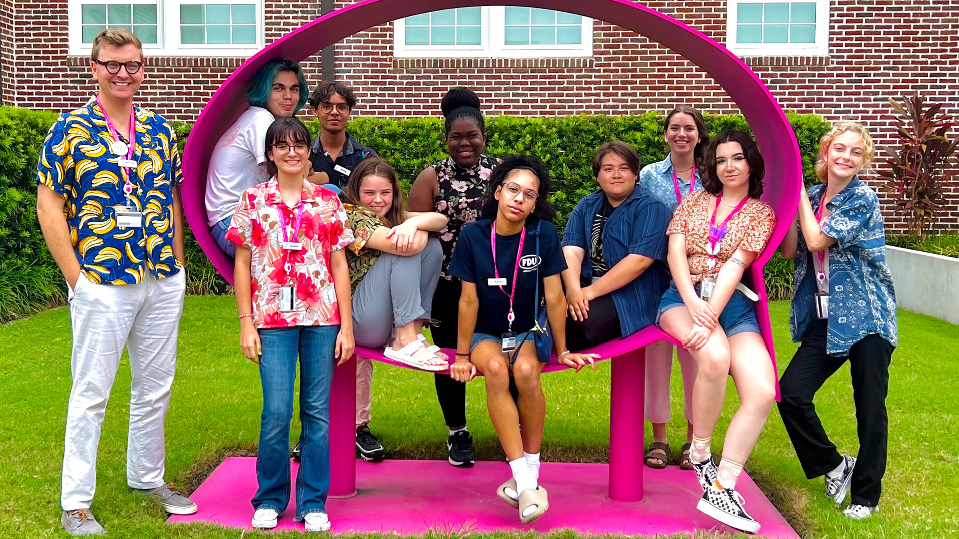 SAM TAC students pose with Hank Willis Thomas sculpture.