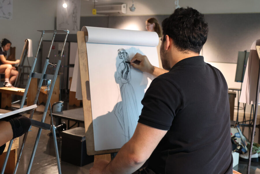 Students draw from a live model in the PreCollege mini workshop How to Draw Characters Wearing Armor.