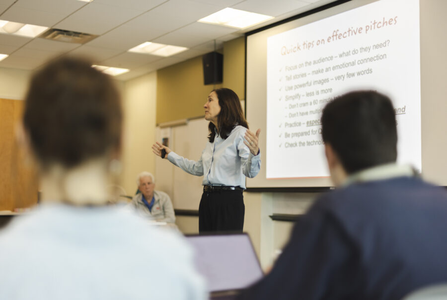 Susan Neal leading students through business workshop.