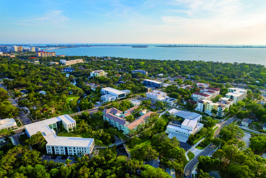 bird's eye view of campus with water in the distant.