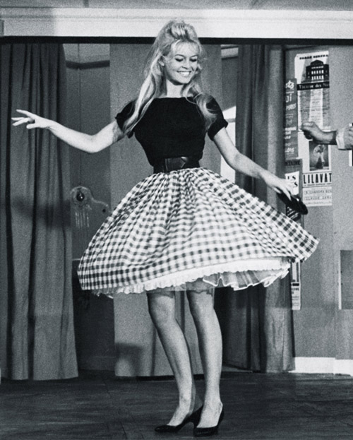 1950s woman dancing in a full skirt and fitted top