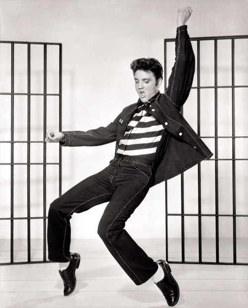 1950s male performer dancing energetically in casual attire