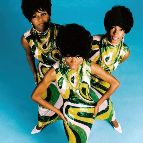 1960s women wearing coordinated patterned dresses against a studio backdrop