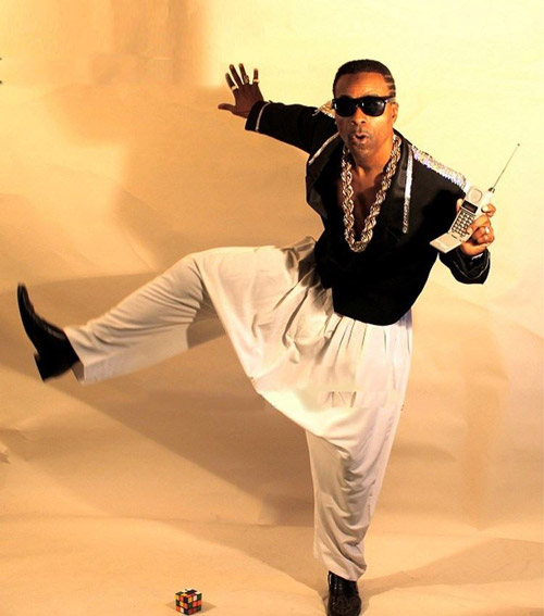 1990s performer wearing loose-fitting clothing and bold accessories