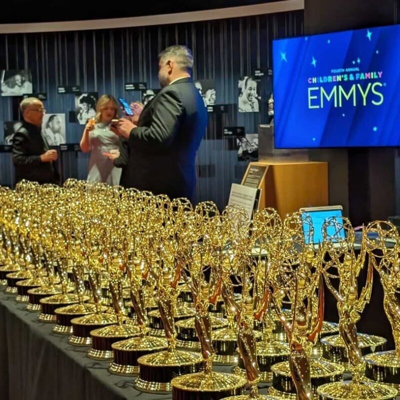 Emmy awards lined up on a table.