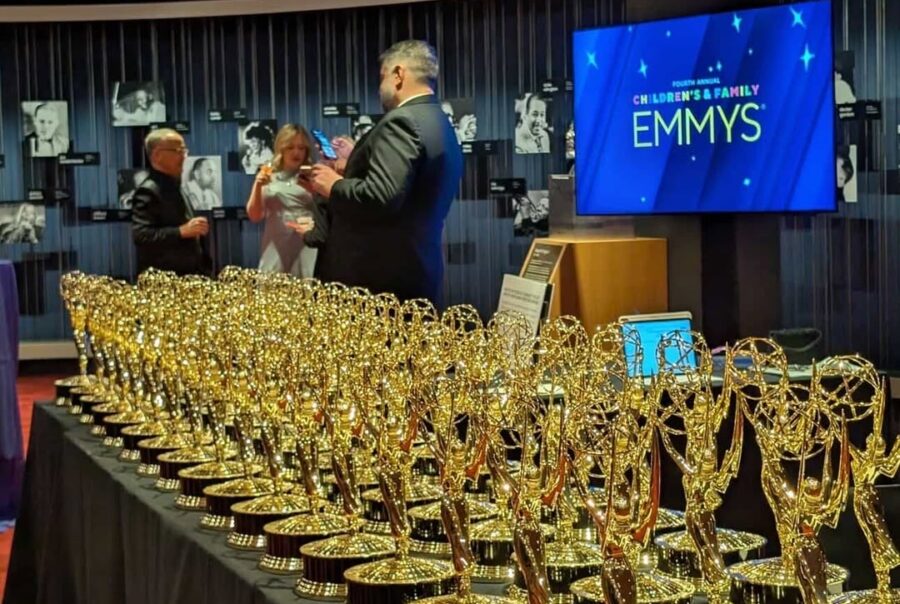 Emmy awards lined up on a table.