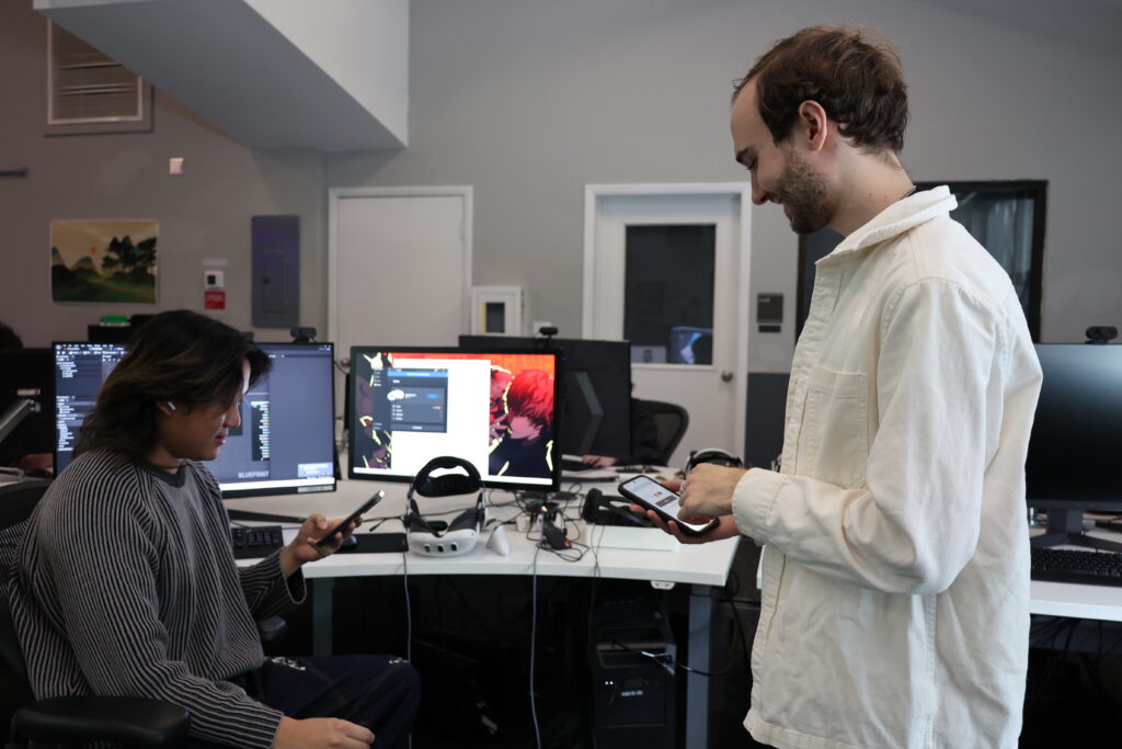 one person standing and one sitting