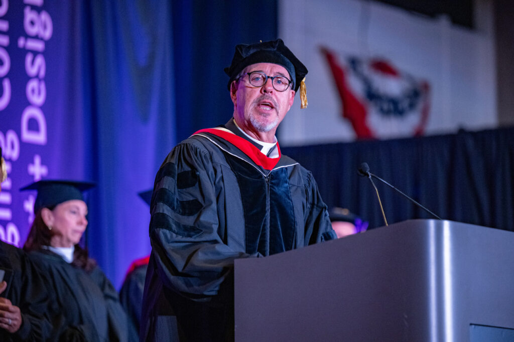 Faculty Address at Commencement Faculty member speaking at the podium during commencement.