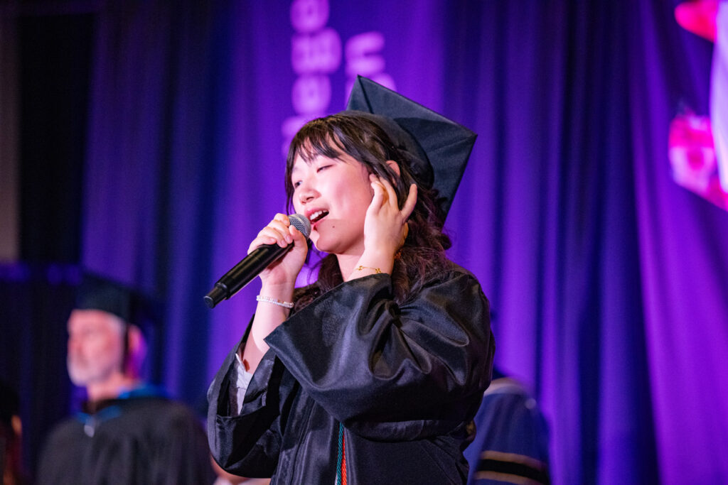 Musical Performance at Commencement Graduate performing vocals during the commencement ceremony.
