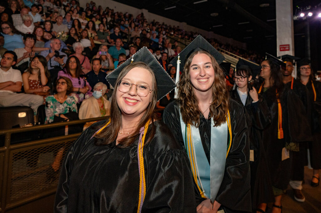 2026 Commencement Ceremony Graduate posing with a friend during Ringling College’s 2026 commencement ceremony.
