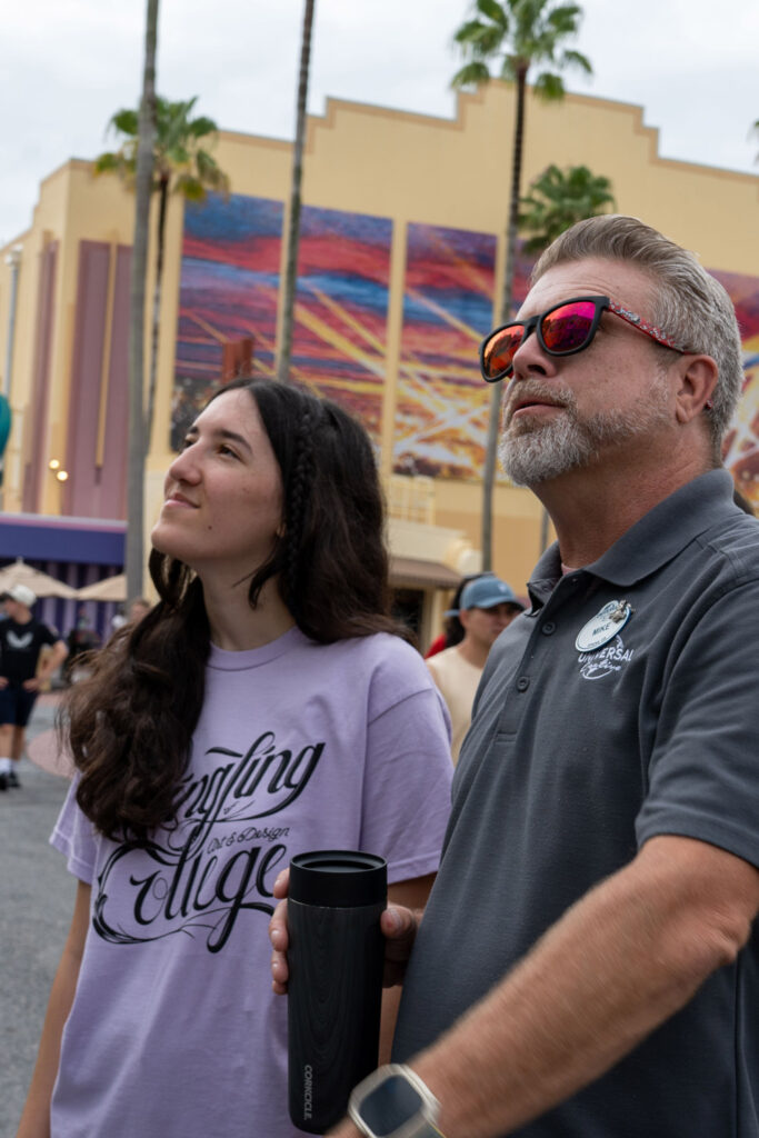 First-place competition winner Ella McGinley with Universal Creative’s Mike Woodcock,
Assistant Director for Graphic Design, Fabrication and Implementation.