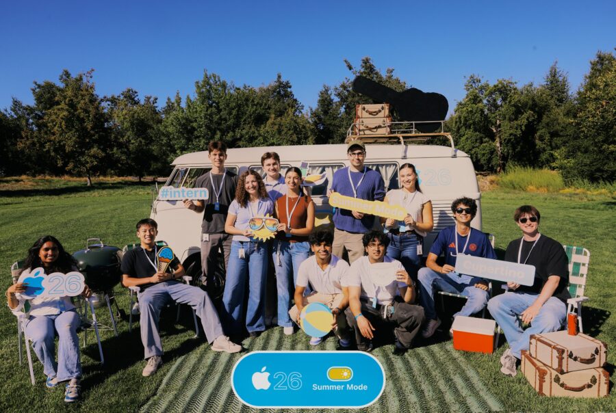 interns posing on a lawn in front of a van